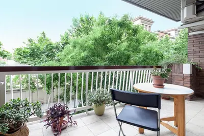 a balcony with a table and potted plants at Key Gracia Apartments in Barcelona