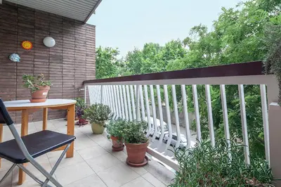 a balcony with a table and potted plants at Key Gracia Apartments in Barcelona