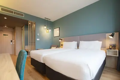a large white bed in a hotel room at Holiday Inn Barcelona - Sant Cugat by IHG in Sant Cugat del Vallès