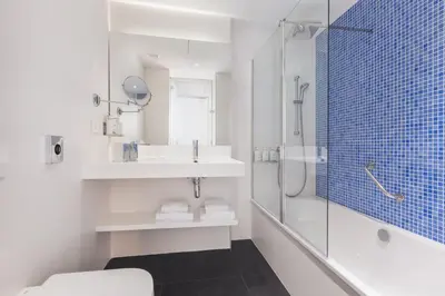 a bathroom with a shower and a toilet and a sink at Holiday Inn Barcelona - Sant Cugat by IHG in Sant Cugat del Vallès