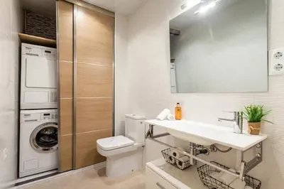 a bathroom with a sink and a washing machine at Casa 20 minutos de Barcelona y WIFI alta capacidad in Sant Cugat del Vallès