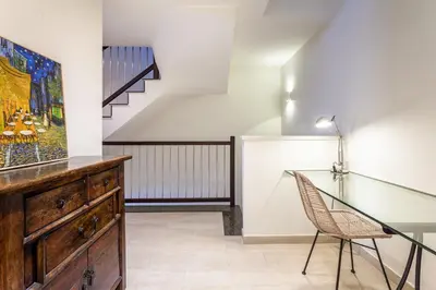 a dining room with a glass table and a chair at Casa 20 minutos de Barcelona y WIFI alta capacidad in Sant Cugat del Vallès