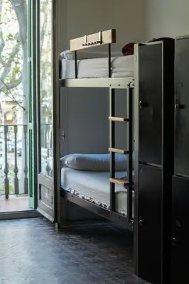 two bunk beds in a room with a window at 360 Hostel Borne in Barcelona