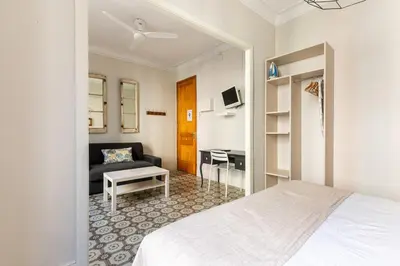 a hotel room with a bed and a couch at Weflating Sant Antoni Market in Barcelona