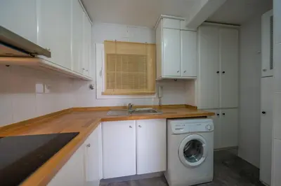 a kitchen with a washing machine and a sink at HomeHolidaysRentals Eiffel - Costa Barcelona in Pineda de Mar