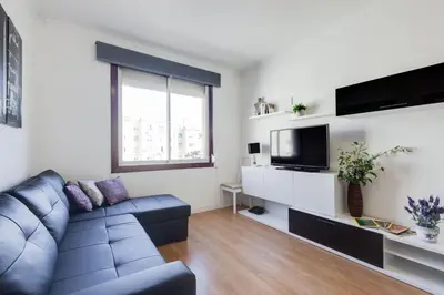 a living room with a couch and a tv at Sagrada Familia LEPANT in Barcelona