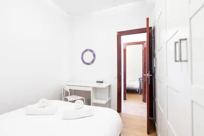a white room with two beds and a desk at Sagrada Familia LEPANT in Barcelona