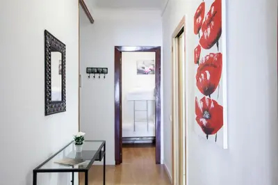 a hallway with red flowers on the wall at Sagrada Familia LEPANT in Barcelona