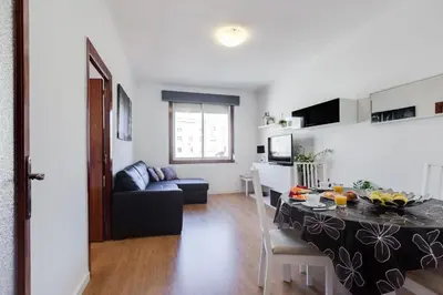a living room and kitchen with a table and a couch at Sagrada Familia LEPANT in Barcelona