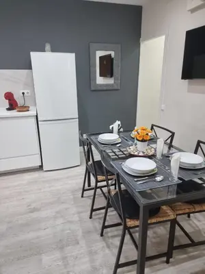 a dining room with a black table and chairs at Barcelona 2 Habitaciones in Hospitalet de Llobregat
