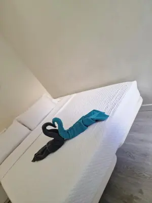 a stuffed animal is sitting on a bed at Barcelona 2 Habitaciones in Hospitalet de Llobregat