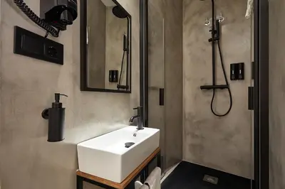 a bathroom with a white sink and a shower at Ella Hostel Ramblas in Barcelona
