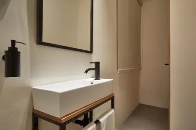 a bathroom with a white sink and a mirror at Ella Hostel Ramblas in Barcelona