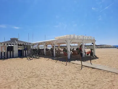a pavilion on the beach with a sandy beach at Bright with pool near the beach and Barcelona by train in Masnou