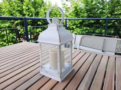 a lantern sitting on top of a wooden table at Bright with pool near the beach and Barcelona by train in Masnou