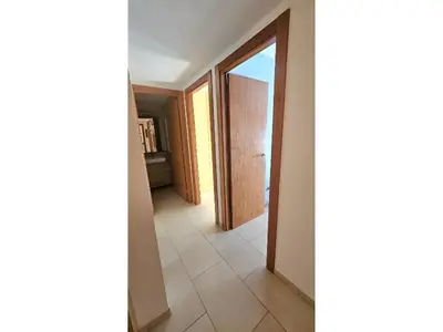 a hallway with a door and a tile floor at Apartament Calella in Calella