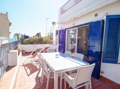 a white table and chairs on a balcony at Carreta Sea Views by Hello Homes Sitges in Sitges