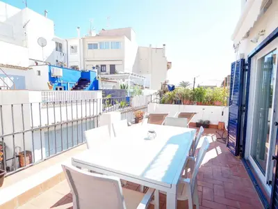 a white table and chairs on a balcony at Carreta Sea Views by Hello Homes Sitges in Sitges