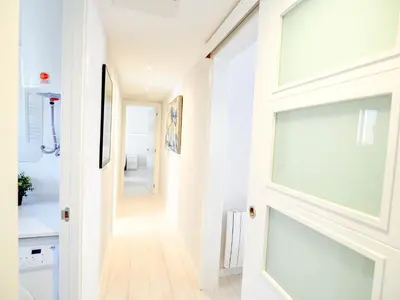 a hallway with a door leading to a bathroom at Carreta Sea Views by Hello Homes Sitges in Sitges