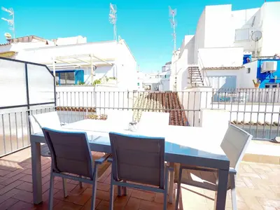a table and chairs on top of a balcony at Carreta Sea Views by Hello Homes Sitges in Sitges