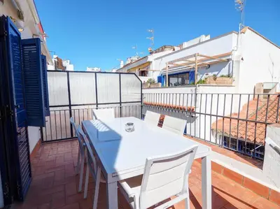 a white table and chairs on a balcony at Carreta Sea Views by Hello Homes Sitges in Sitges