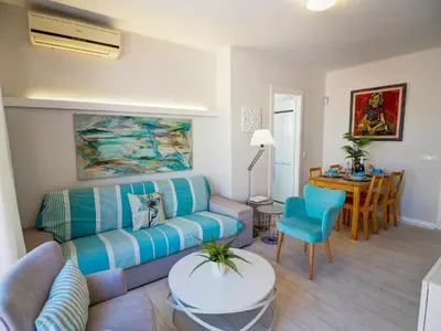 a living room with a couch and a table at Carreta Sea Views by Hello Homes Sitges in Sitges
