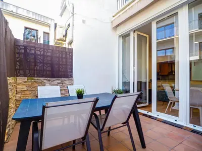 a blue table and chairs on a patio at La Cubana Apartment by Hello Homes Sitges in Sitges