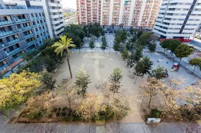 an aerial view of a park with trees and buildings at Modern Luxury Apartment Fira Bcn in Hospitalet de Llobregat