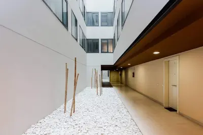 a hallway of a building with a white rug at Modern Luxury Apartment Fira Bcn in Hospitalet de Llobregat