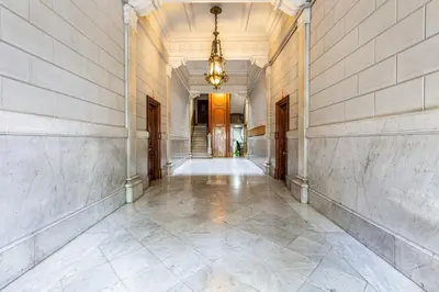 an empty hallway of a building with a chandelier at Luxury Paseo de Gracia Casa Batlló in Barcelona