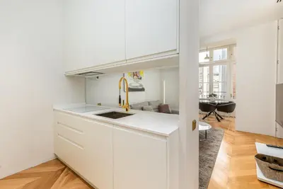 a kitchen with white cabinets and a sink at Luxury Paseo de Gracia Casa Batlló in Barcelona