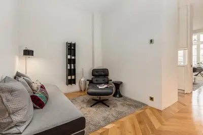 a living room with a chair and a couch at Luxury Paseo de Gracia Casa Batlló in Barcelona