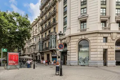 a street in a city with a large building at Luxury Paseo de Gracia Casa Batlló in Barcelona