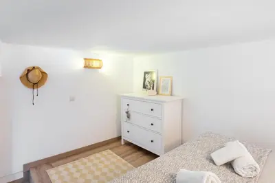 a white bedroom with a bed and a dresser at Stay U-nique Apartments Travessera II in Barcelona