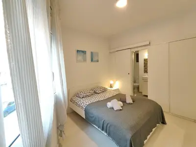 a bedroom with a bed with two towels on it at Family apartment close to Parc Güell in Barcelona