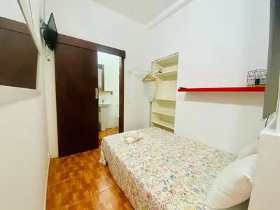a small bedroom with a bed and a closet at 01 Apartamento 2 ,3 in Barcelona