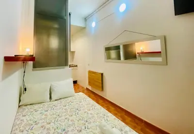a bedroom with a bed and a mirror on the wall at 01 Apartamento 2 ,3 in Barcelona