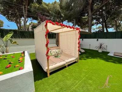 a gazebo with a bed in a yard at Arena Castelldefels in Castelldefels