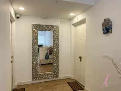 a hallway with a mirror on a wall at Arena Castelldefels in Castelldefels