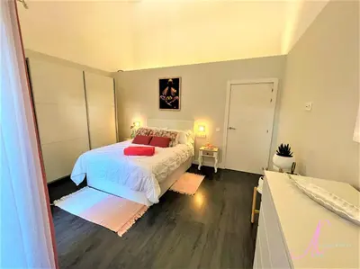 a bedroom with a bed with red pillows on it at Arena Castelldefels in Castelldefels