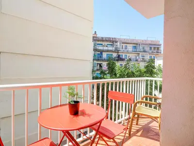 a balcony with a table and two chairs and a building at Golden Sands by Hello Homes Sitges in Sitges