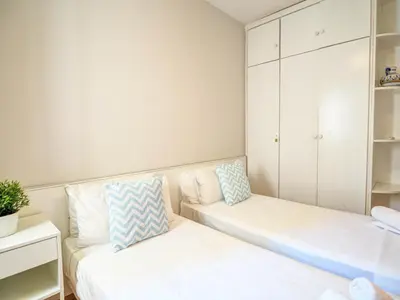 a small room with a couch and a cabinet at Golden Sands by Hello Homes Sitges in Sitges