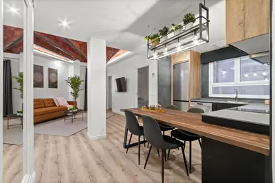 a kitchen and living room with a table and chairs at Tendency Apartments 5 in Barcelona