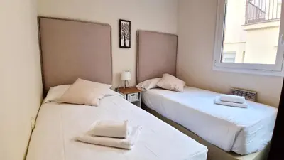 two beds sitting next to each other in a room at Modern apartment close to the Camp Nou Stadium in Barcelona