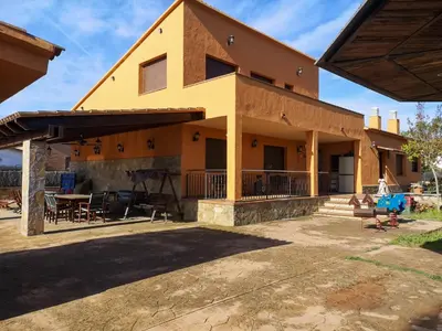 a house with a porch and a patio at Casa Martina in Cardedeu