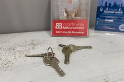 two keys sitting on a counter next to a box at Be Barcelona Eixample Arco del Triunfo in Barcelona