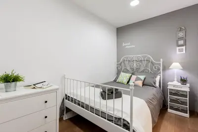 a bedroom with a bed with a white crib at Be Barcelona Eixample Arco del Triunfo in Barcelona