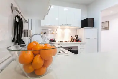 a bowl of oranges sitting on top of a kitchen counter at Be Barcelona Eixample Arco del Triunfo in Barcelona