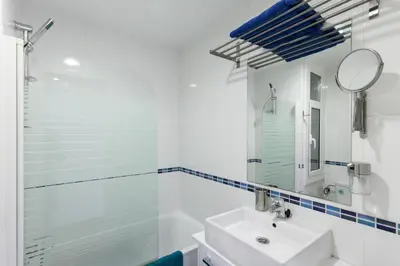a white bathroom with a sink and a mirror at Be Barcelona Eixample Arco del Triunfo in Barcelona