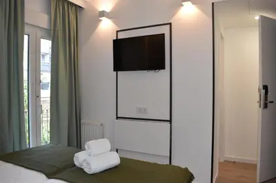 a bedroom with a flat screen tv on the wall at Casp Green House in Barcelona